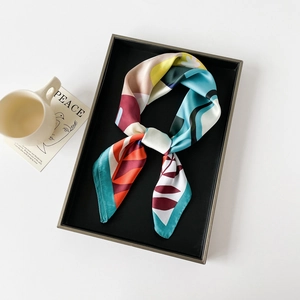 Detailed view of 70x70cm silk scarf with abstract botanical patterns and vivid colors