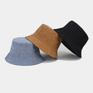 Detail shot of corduroy bucket hats in blue, brown, and black with textured stripes