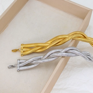 Detail of three-strand braided snake bone chains in gold and silver with lobster clasp