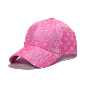 Detailed close-up of pink paisley print on a cotton baseball cap with curved brim