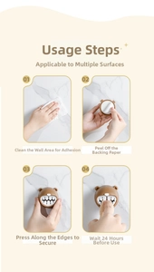 Four-step installation guide for bear towel holder showing adhesive backing and wall mounting