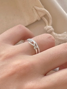 Detailed view of S925 silver double-band ring with hollow fish design on a finger