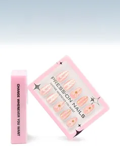 Detail of 3D embossed floral press-on nails with pearls and pink display box