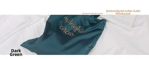 Detailed view of dark green satin tote bag featuring golden midnight circus embroidery