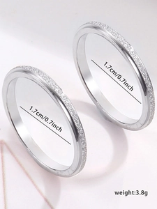 Detail showing two frosted silver stainless steel rings with diameter and weight specs