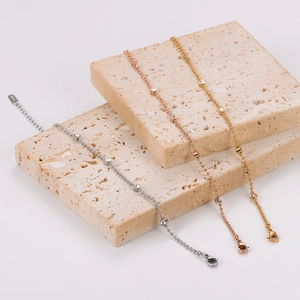 Macro detail of bead chain bracelets with rhinestones on marble blocks