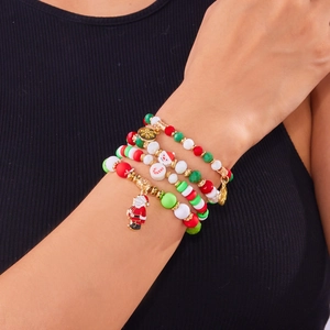 Close-up of four-piece Christmas beaded bracelets with Santa and snowflake charms