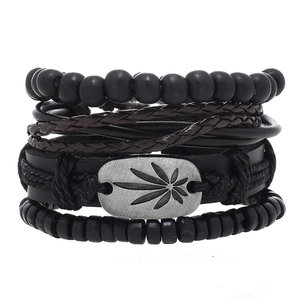 Macro shot of 4-piece leather bracelet set including beads and cannabis leaf metal charm