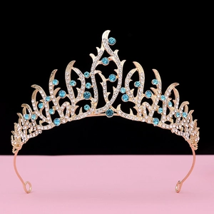 Detailed view of Baroque crown featuring light blue rhinestones on a gold hollow base