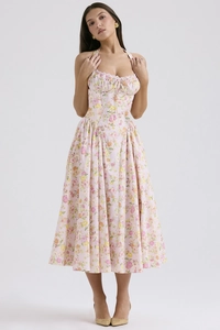 Detail of pink floral dress featuring a halter neckline and structured corset waist design