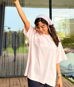 Detail of pink cotton oversized T-shirt with 'Girls Just Wanna Have Fun!' graphic print