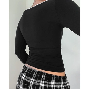 Detail view of square neck long sleeve top with white lace trim and bow on the back