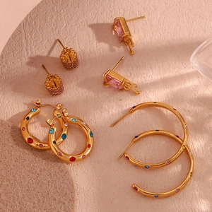 Flat lay of gold plated stainless steel earrings with colorful zircon stones and gems