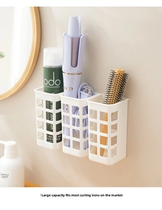 Wall-mounted white mesh storage baskets for hair styling tools and curlers in bathroom