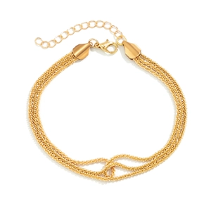 Detailed macro view of layered gold braided chain bracelet with lobster clasp and extender