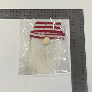 Detailed measurement of knitted Christmas gnome bottle cover with white beard and striped hat