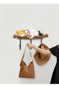 Detail showing Nordic resin chef wall hooks with bags and a hat for home organization
