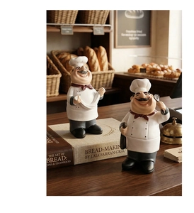 Detail of chef resin ornaments in bakery scene showing classic uniforms and craftsmanship