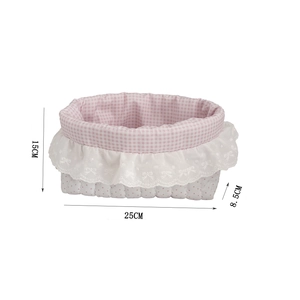 Detail showing pink polka dot and checkered fabric storage basket with white lace trim