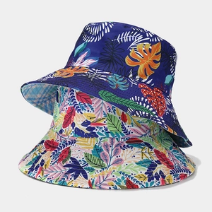 Fashionable reversible wide-brim sun hat with tropical floral patterns in blue and white