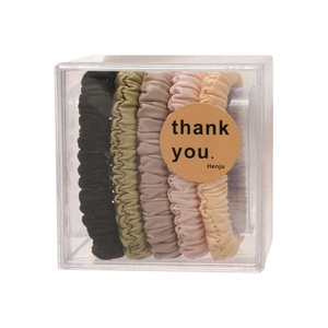 Five-piece set of pleated fabric hair scrunchies in earth tones within a clear gift box