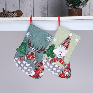 Close-up of reindeer and polar bear Christmas stockings hanging on a white shelf