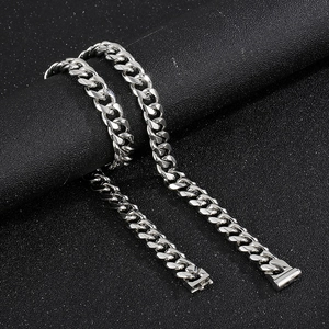 Macro view of 13mm silver Cuban link chain with metallic luster on textured background