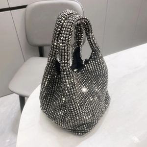 Detailed close-up of sparkling rhinestones on the elegant silver-black bucket evening bag
