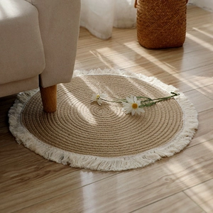 Nordic round cotton rope jute rug with tassels on light wood floor in cozy room