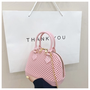 Detailed close-up of pink shell bag featuring bubble texture and golden chain strap