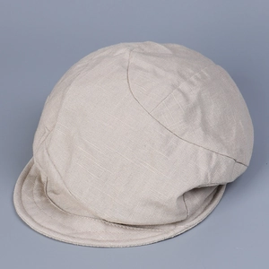 Close-up of the breathable linen fabric texture and stitching on this beige flat cap