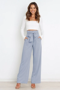 Detail of high-waisted wide-leg pants featuring a stylish bow tie-belt in light blue