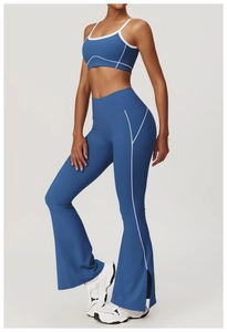 Detail of high-waisted yoga flared pants with white contrast stitching and side slits