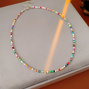 Macro shot of colorful glass seed bead necklace with silver lobster clasp and extender