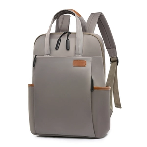 Waterproof grey nylon laptop backpack with brown leather trim for travel and commute