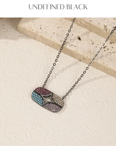Detail of gunmetal plated S925 silver necklace with colorful zircon hollow star pendant