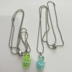 Luminous turtle heart magnetic necklaces in light green and blue with silver bead chains