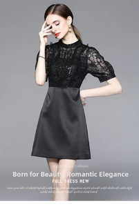 Detail of elegant black dress showing heavy beadwork and lace embroidery on the bodice