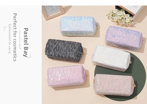Close-up of sequin makeup bags in six colors with decorative pearl zipper pulls