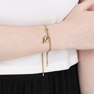 Detail of adjustable 18K gold plated snake chain bracelet with heart pendant and tassels