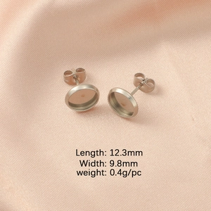 Macro view of silver stainless steel earring post base with size dimensions on pink silk