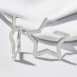 Macro view of sterling silver star stud earrings with brilliant full diamond pavé finish