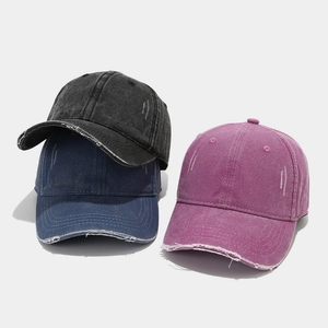 Macro shot showing distressed brim details and vintage washed fabric of baseball caps