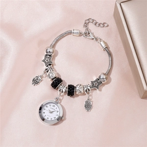 Dettaglio dell'orologio bracciale con perline e ciondolo gufo con strass neri brillanti