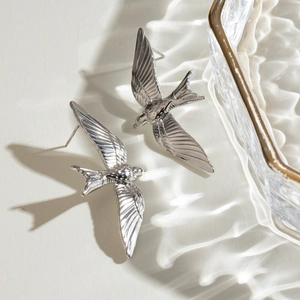 Polished silver stainless steel swallow bird stud earrings shown from a 3D perspective