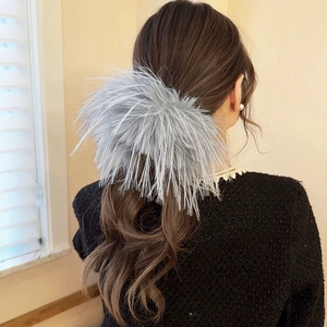 Large grey feather hair scrunchie shown on a ponytail for an elegant hairstyle