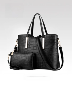 Close-up of black crocodile pattern 2-piece tote set with gold metal accents