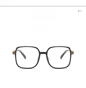 Detail of glossy black square frame glasses with elegant gold metallic temple accents
