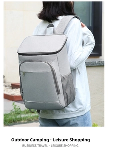 Macro shot of light grey insulated backpack with mesh side pocket and zipper detail