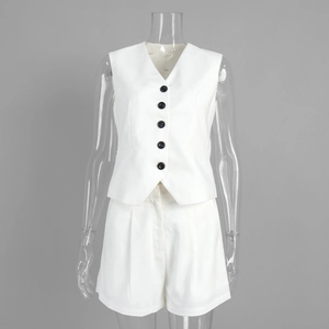 Detailed view of white V-neck vest and matching shorts set with black buttons